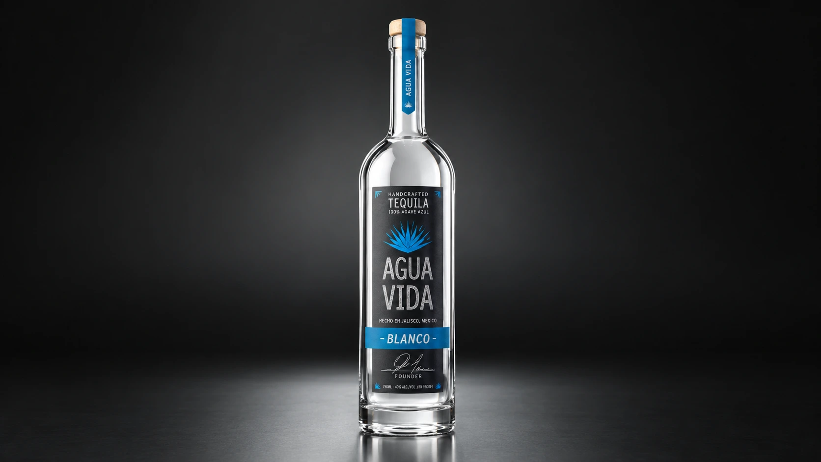 Agua Vida Blanco bottle in low studio light, the agave emblem and label detail catching the light